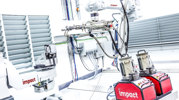 An impact innovations cold spraying cell showing spray guns in action.
