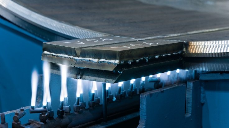 Close up of LINDOFLAMM special burners showing white flames heating a metal part of a wind tower.