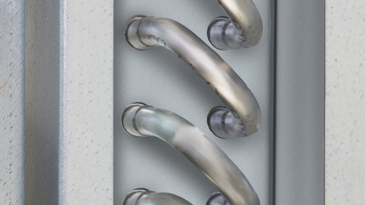 A close-up of Linde's NITROBOOST fin tube heat exchanger coils inside an insulated unit.