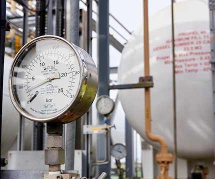 “Close-up of pressure gauge on tank and piping installation”